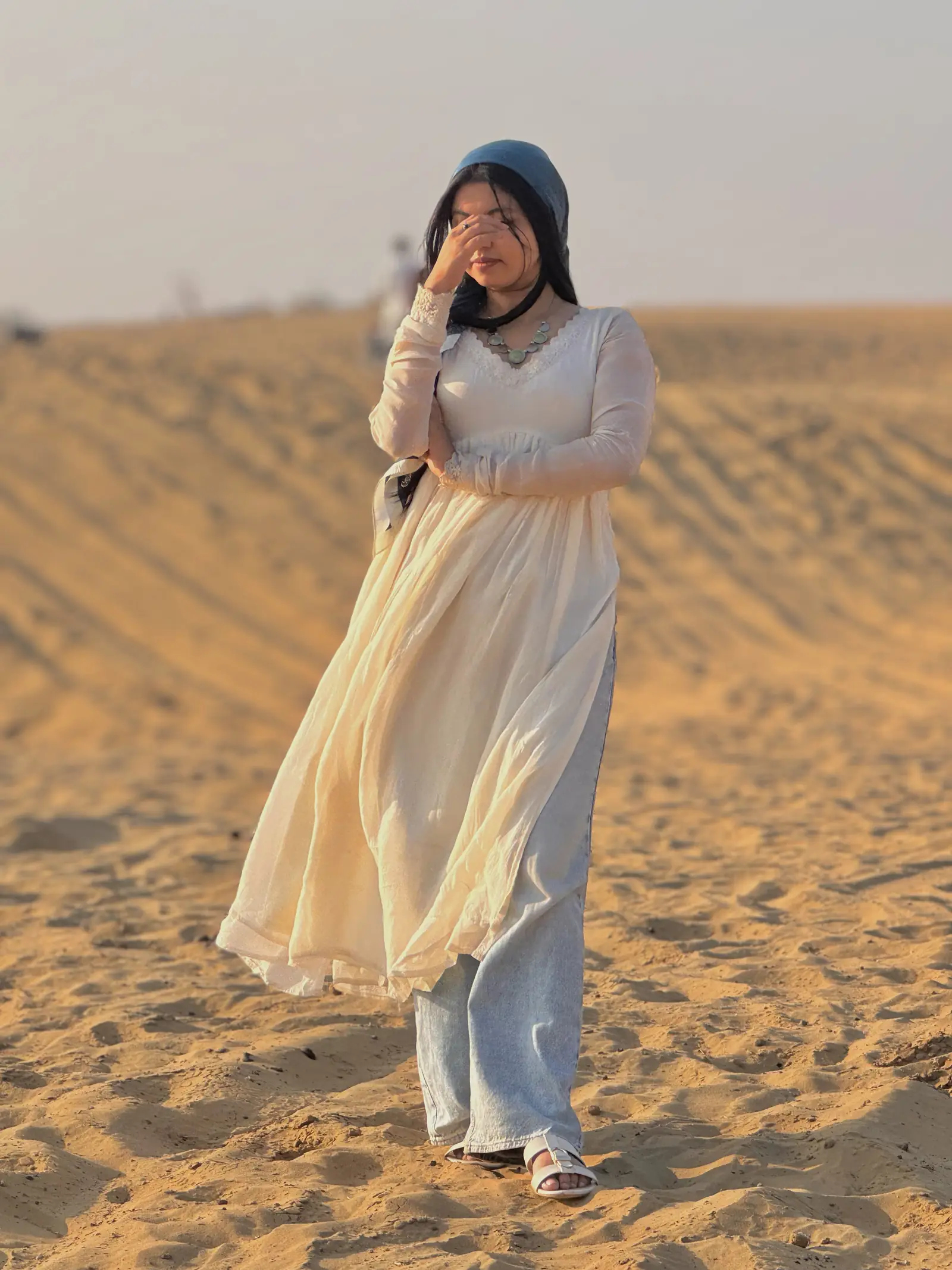 A guest walking out on the dunes in the late afternoon
