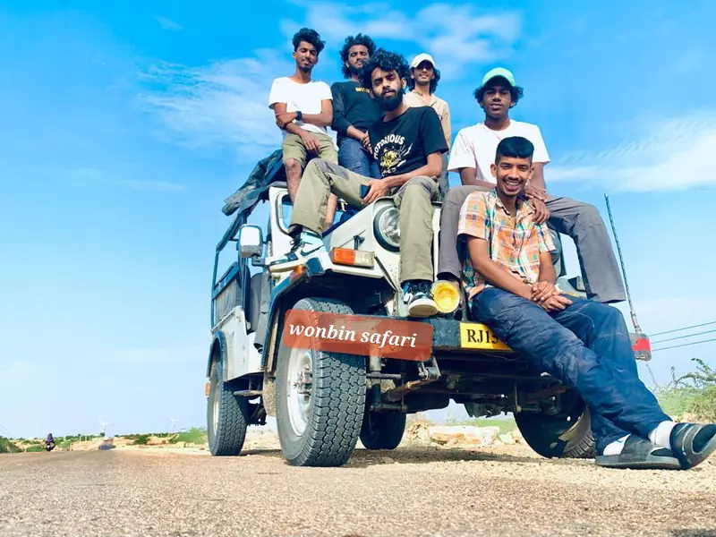 A group packed onto the front of the jeep before setting off