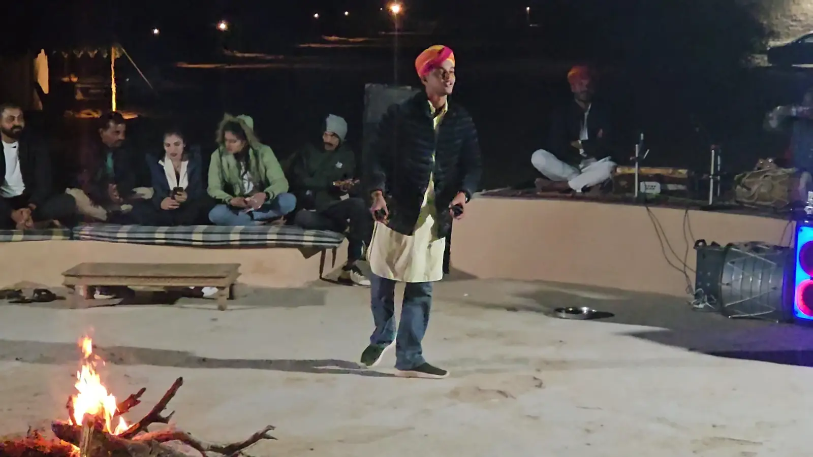 A Rajasthani musician playing beside the fire at the evening programme