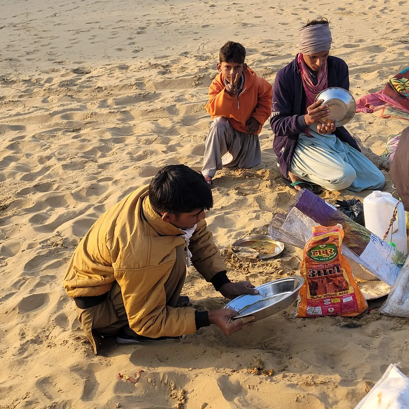 The crew preparing the evening meal on the sand