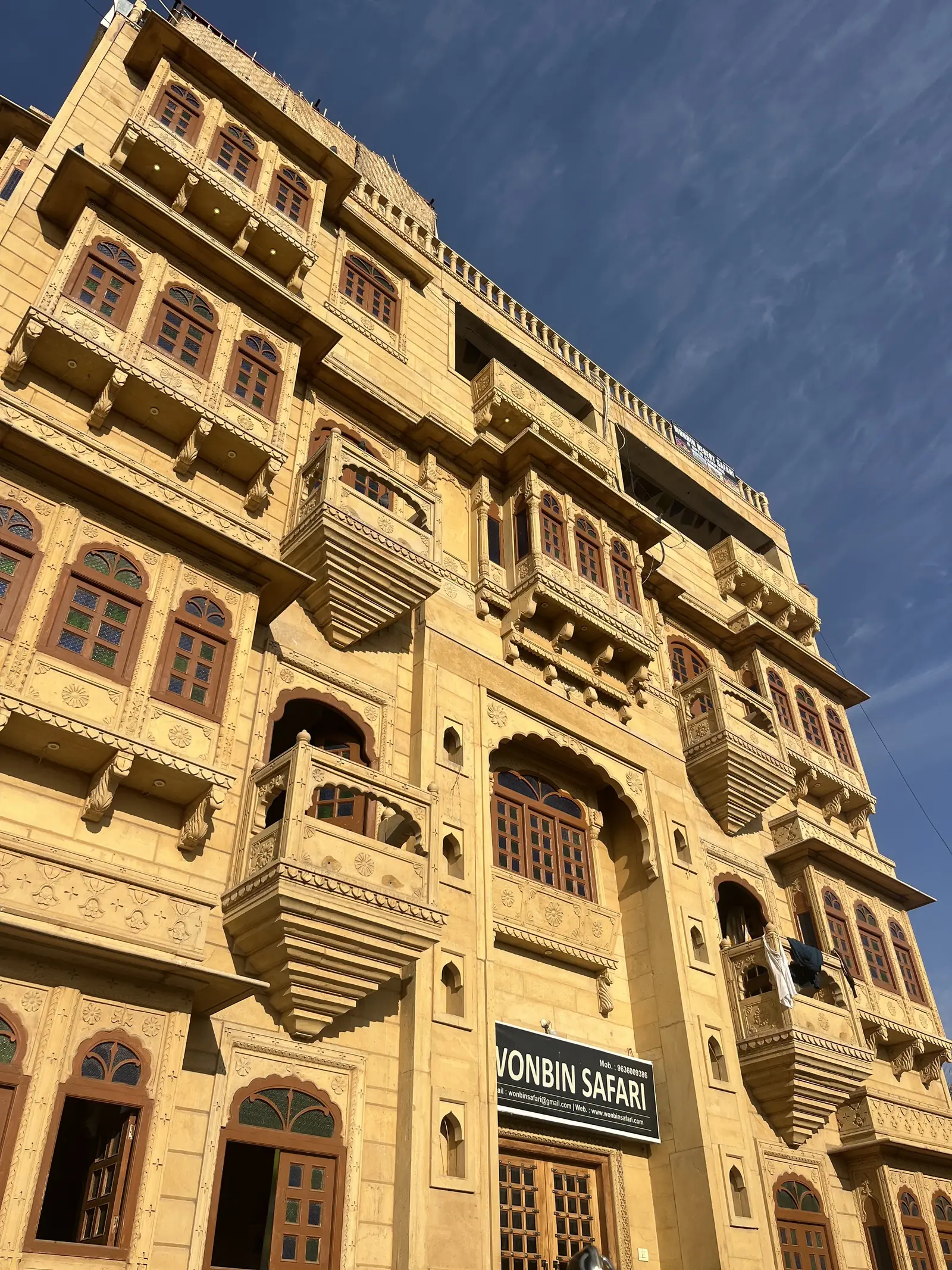 The carved front of the building, balconies on every floor