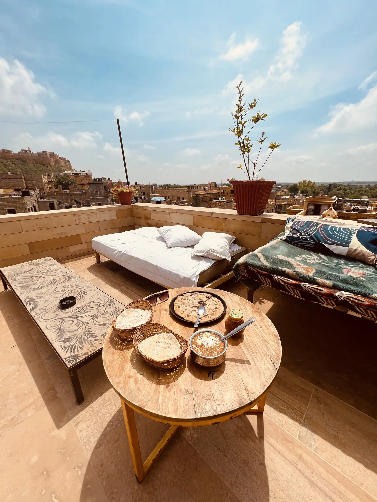 A daybed and a low table on the roof, the fort behind