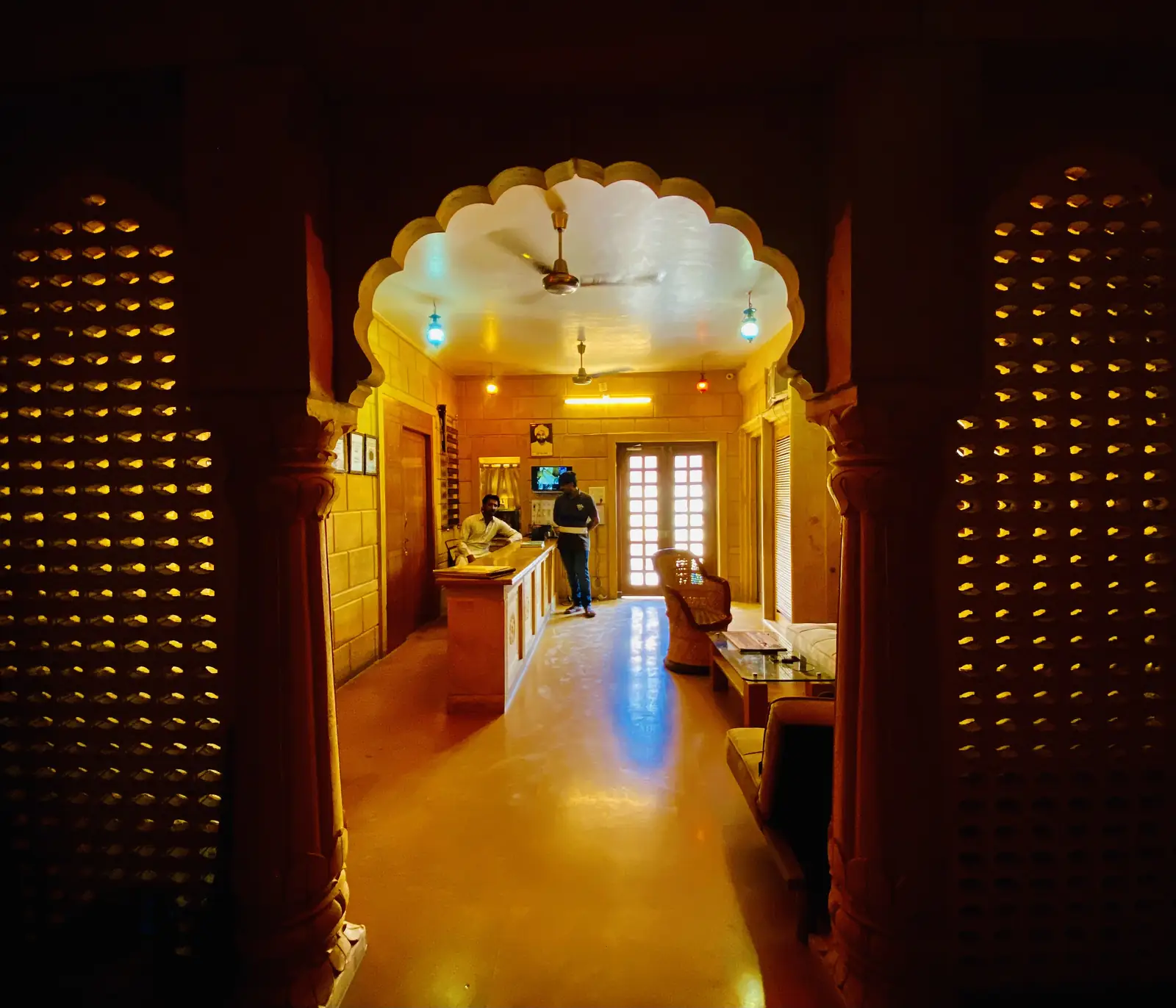 The corridor inside, an arched doorway at the end