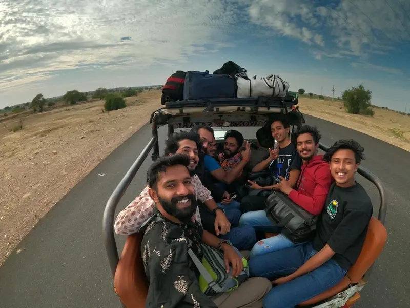 Guests packed into an open jeep with the luggage strapped to the roof, setting off from Jaisalmer