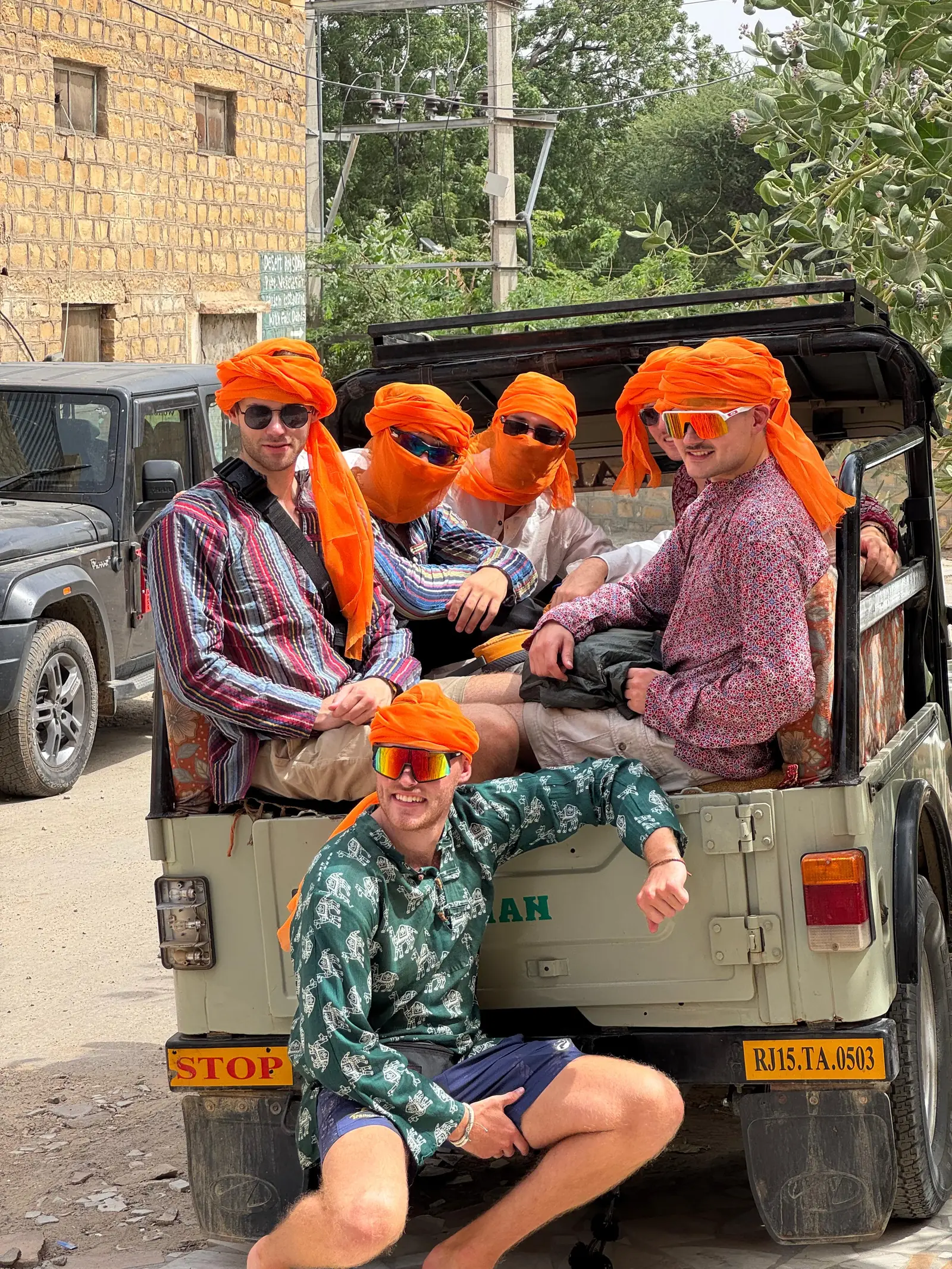 Guests in orange turbans crowded into the back of the safari jeep before the drive out