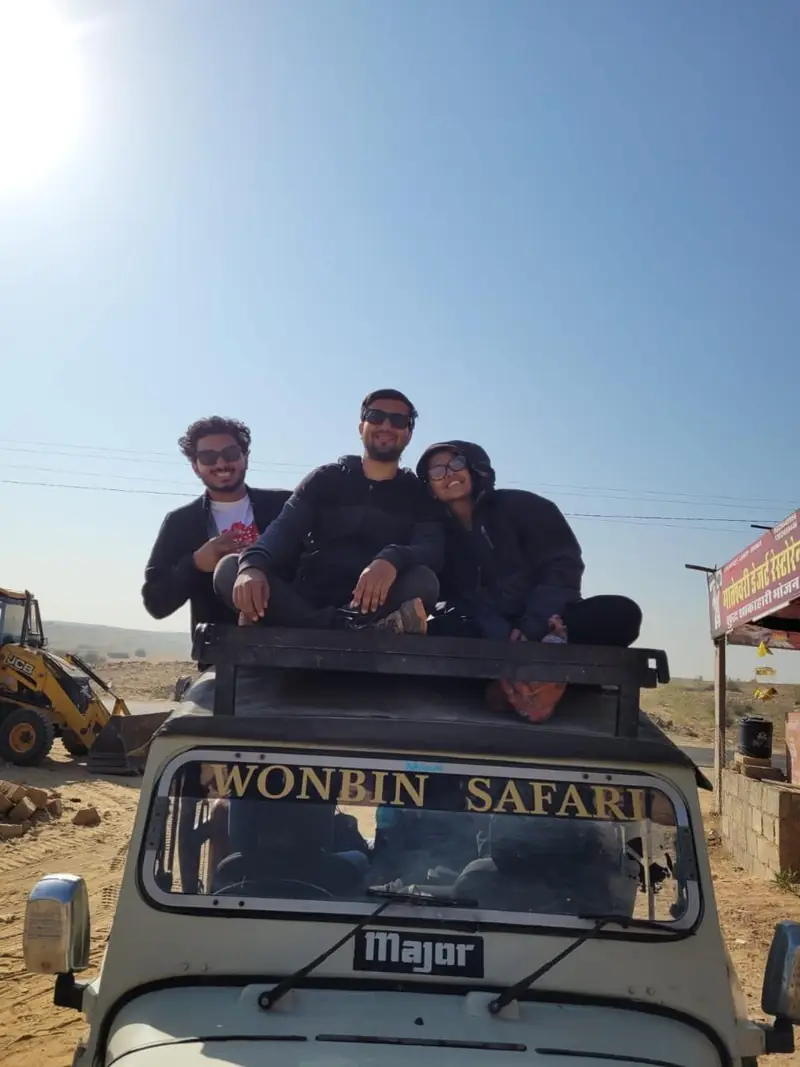 Guests on the bonnet of the Wonbin Safari jeep, its name painted across the front