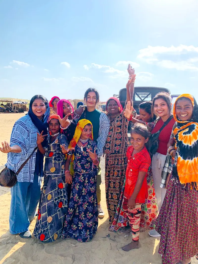 Guests in Rajasthani dress beside the jeep before the drive out to the camp