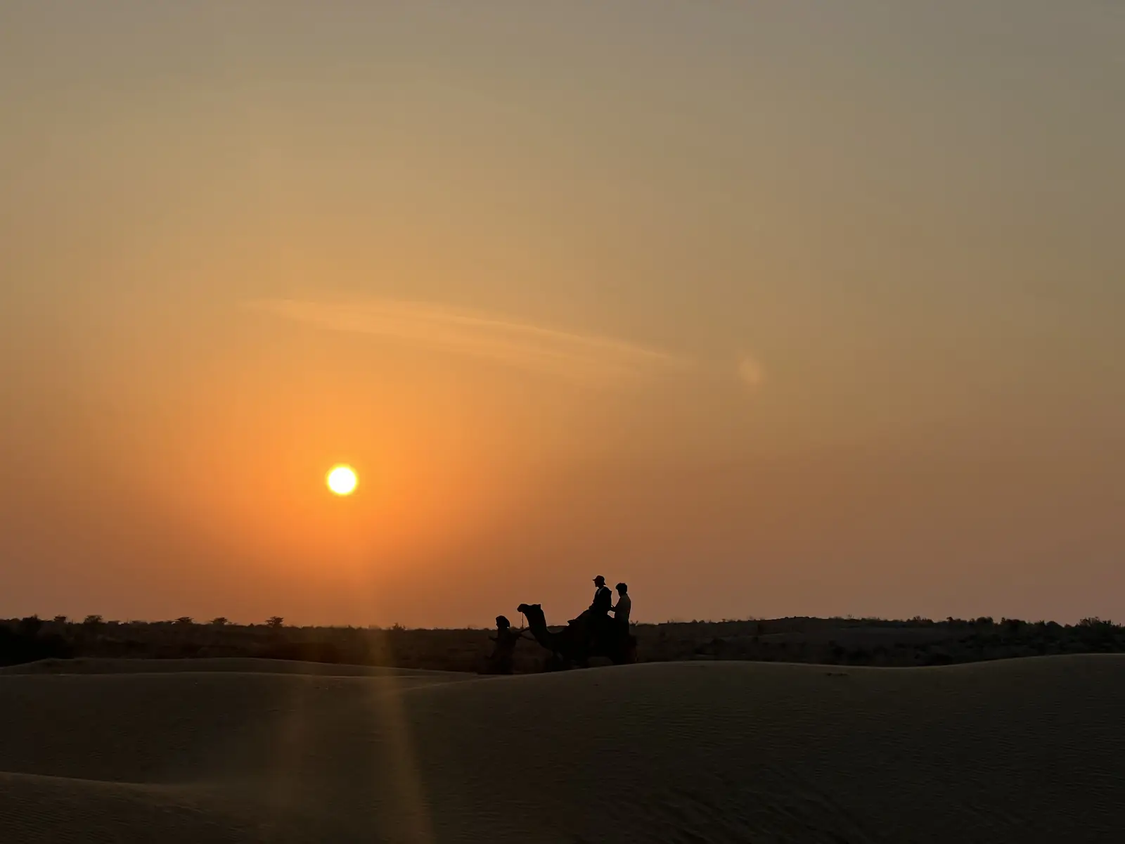 The sun setting across open dunes with nothing else in the frame