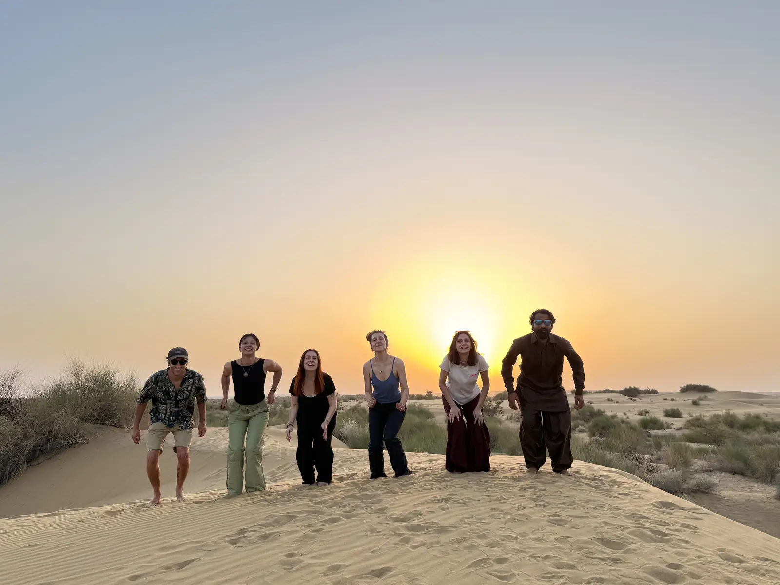 The whole group walking towards the camera with the sun behind them