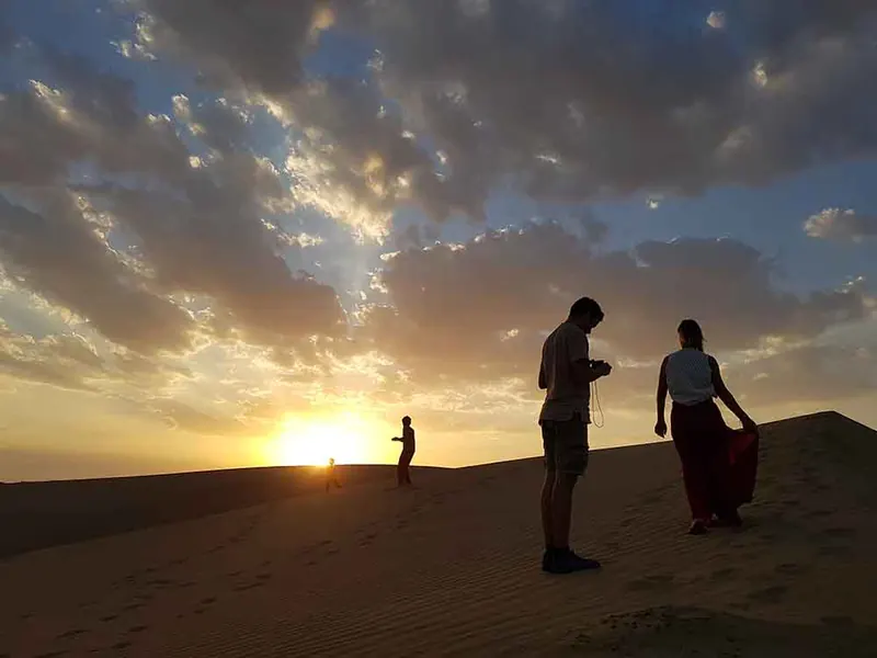 Guests watching the sun go down from a dune in the Thar desert