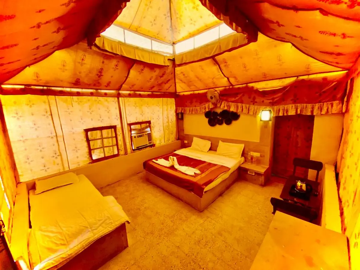 The warmly lit interior of a Swiss luxury tent at the Wonbin desert camp