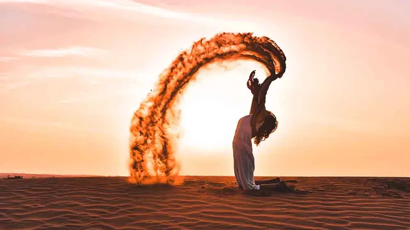 A fire dancer spinning a ring of flame against the sunset in the Thar desert
