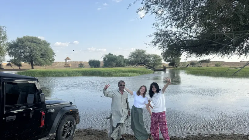The safari jeep and guests beside an oasis pool deep in the Thar desert